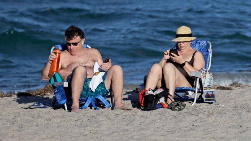 Beachgoers enjoy the warm weather on Wednesday, May 22, 2024, in Deerfield Beach. (John McCall/Sun Sentinel/Tribune News Service via Getty Images)